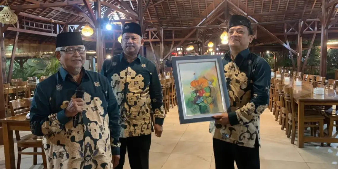 Dewan Penasihat (Wanhat) KH Munawar Amin Jauhari, memberikan cenderamata kepada Ketua DPD LDII Surabaya, Akhmad Setiadi. Foto: LINES