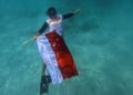 Warga LDII Tabanan Ramaikan HUT RI dengan Pengibaran Bendera Bawah Laut dan Jalan Sehat